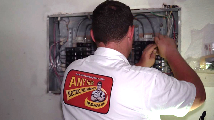 Any hour Services electrician working on an electrical panel