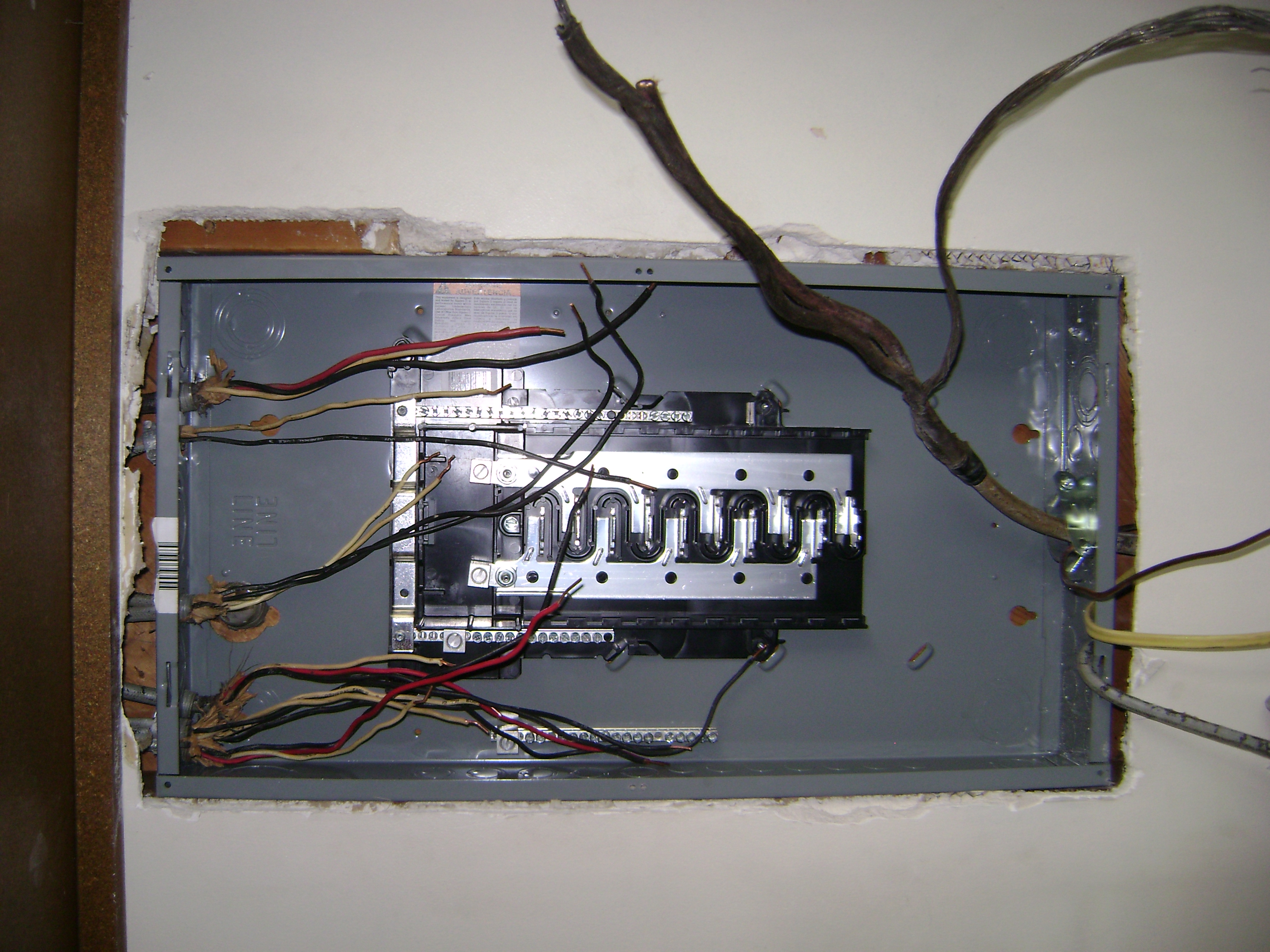 electrical panel with loose and messy wires