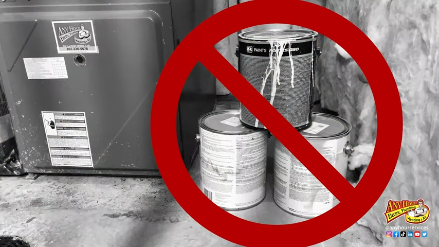 3 cans of paint stacked next to a furnace with a no symbol covering them