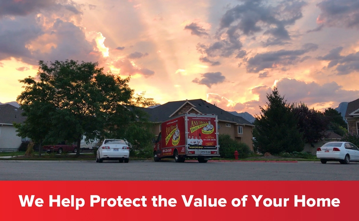 A vibrant sunset sky over suburban homes with a service vehicle in the driveway. A bold red banner states, We Help Protect the Value of Your Home.