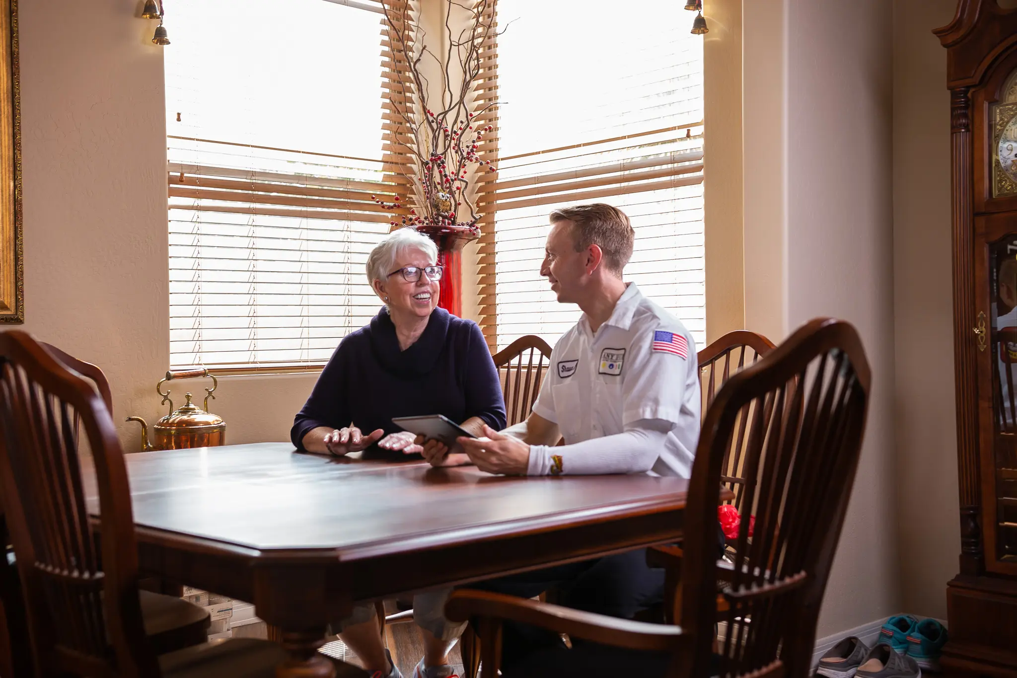 an any hour technician and woman sitting at a table