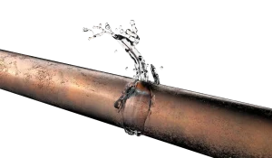 Copper pipe with a noticeable crack, spurting water in a dynamic arch against a black background, illustrating plumbing issues and urgency.