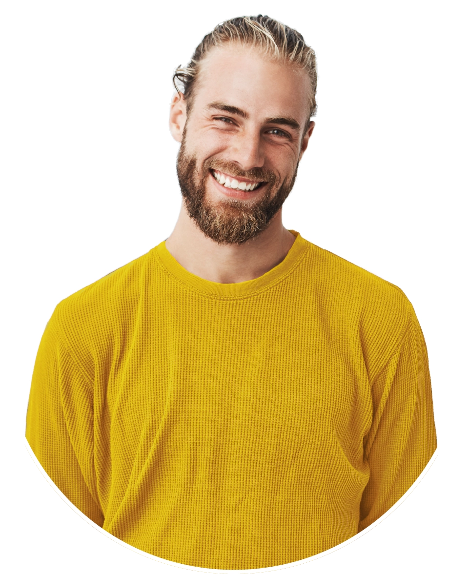 man in a yellow shirt smiling at the camera