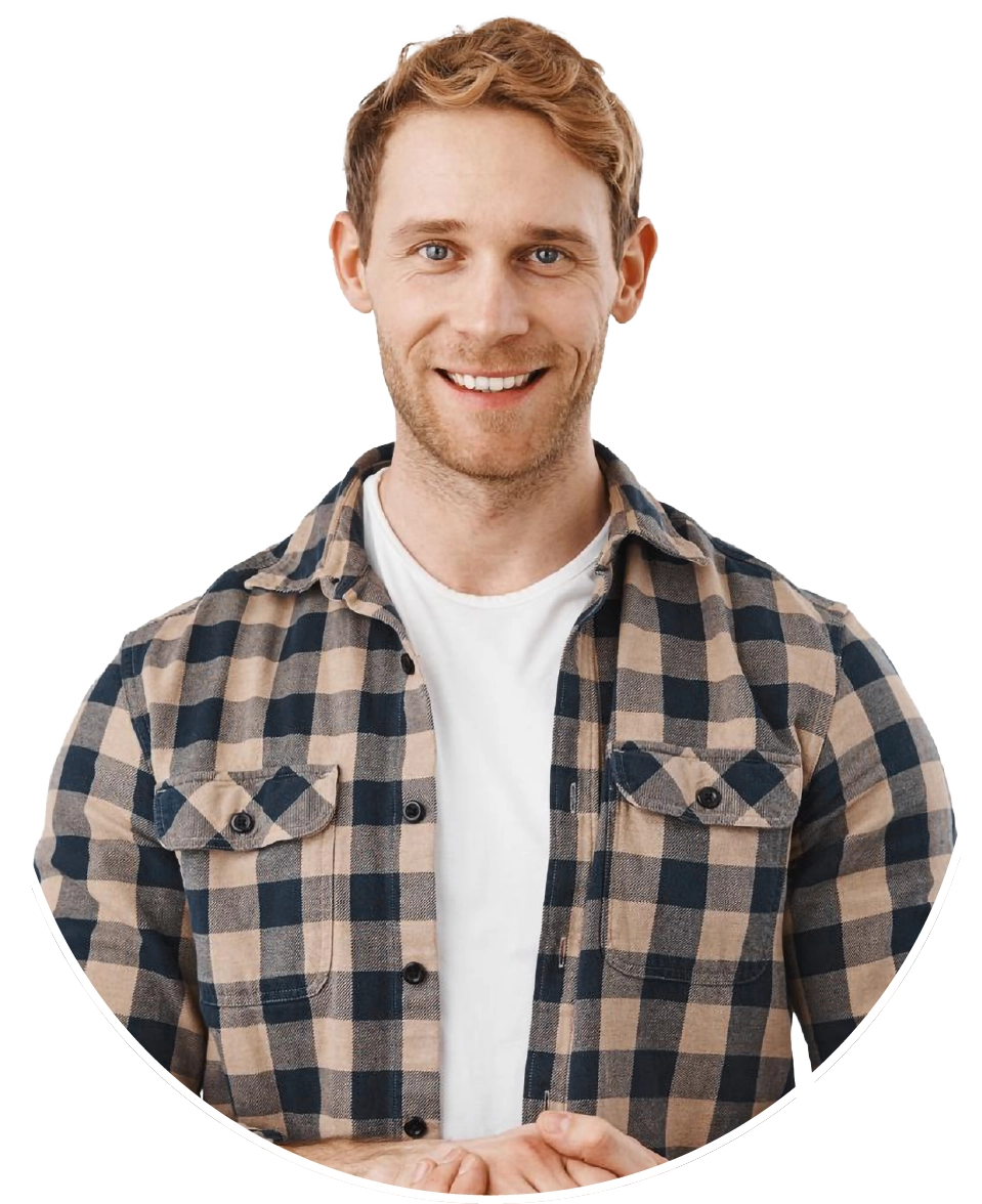 man in a white shirt and unbuttoned flannel smiling at the camera