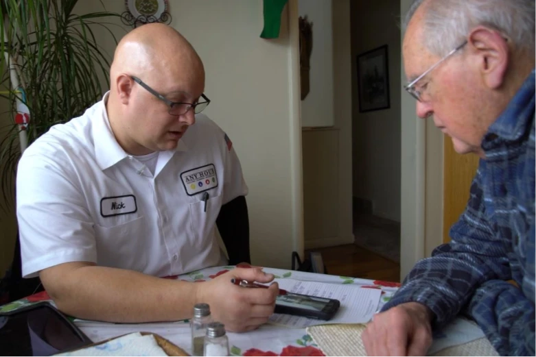 any hour technician and customer review job details at a table