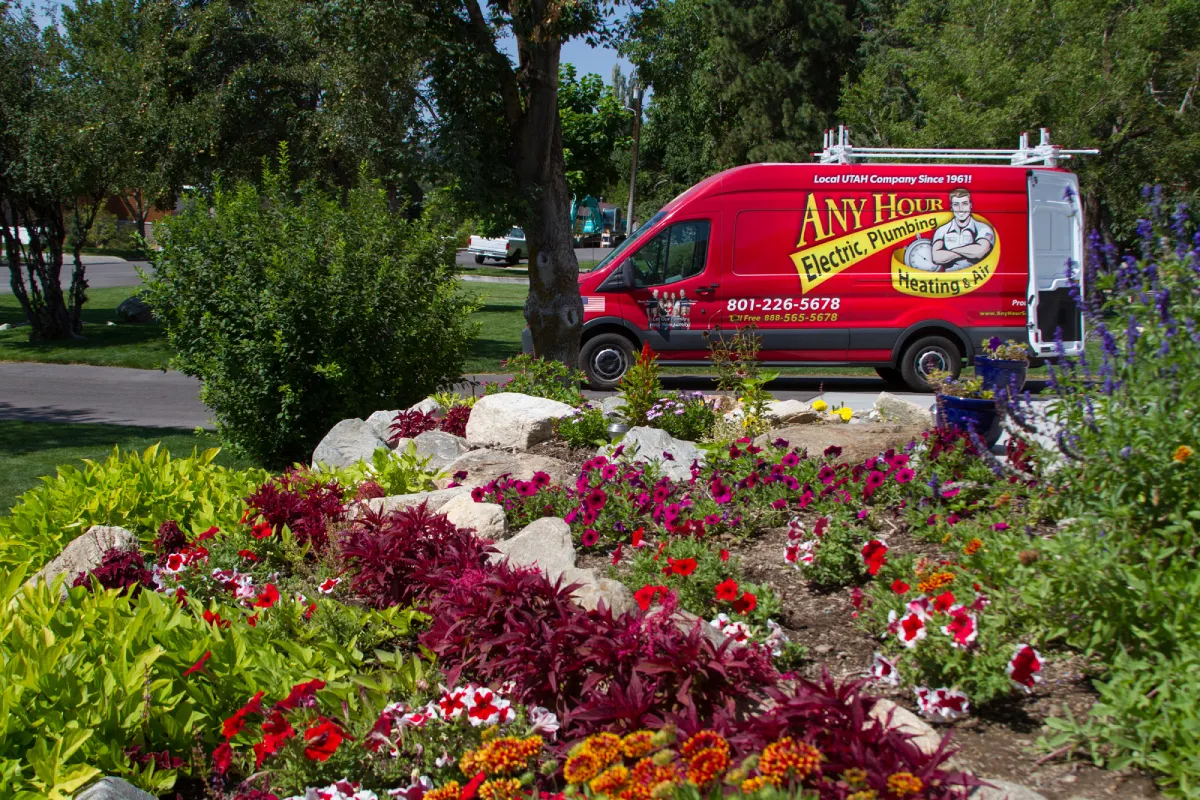 any hour service truck parked behind a garden bed