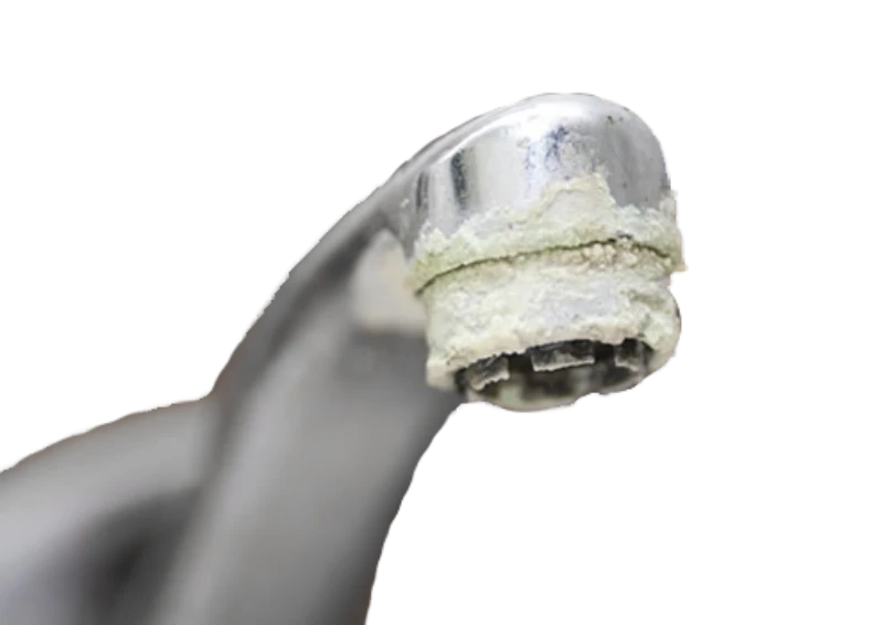 Close-up of a metal faucet spout with a thick white buildup of limescale around the tip, a common sign of hard water in Utah homes.