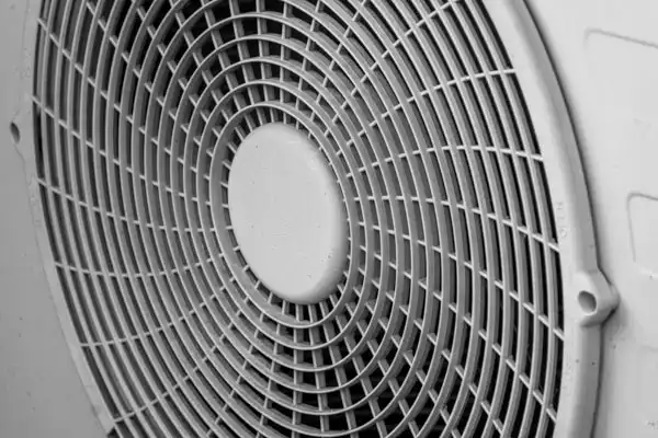 Close-up view of the protective grille covering an electric fan or heat pump unit, ideal for showcasing Heat Pump Repair services in Salt Lake City, UT.