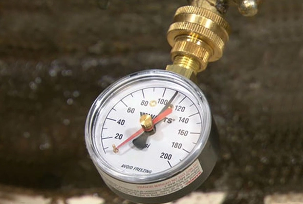 %Imagetitle% | Any Hour Services A close-up of a pressure gauge with a brass fitting, showing a reading slightly above 60 PSI on a scale from 0 to 200 PSI—perfect for illustrating water pressure explained.