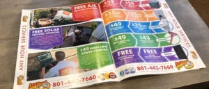 %Title% | Any Hour Services An open magazine displays an advertisement for Any Hour Services, featuring September 2024 promotions with coupons for HVAC, plumbing, drains, electrical, and solar services, along with contact information.