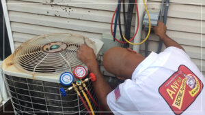 %Title% | Any Hour Services A technician in a company uniform repairs an outdoor air conditioner next to a house, using tools and gauges connected to the system for precise refrigerant adjustments.