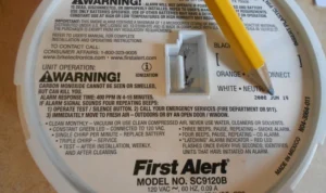 %Title% | Any Hour Services Close-up of a First Alert smoke and carbon monoxide detector with a yellow pencil pointing at the battery compartment. Warning and installation instructions highlight the serious business of preventing carbon monoxide poisoning.