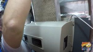 A person replaces an air filter in an HVAC unit; the Any Hour Services logo is visible in the bottom right corner.